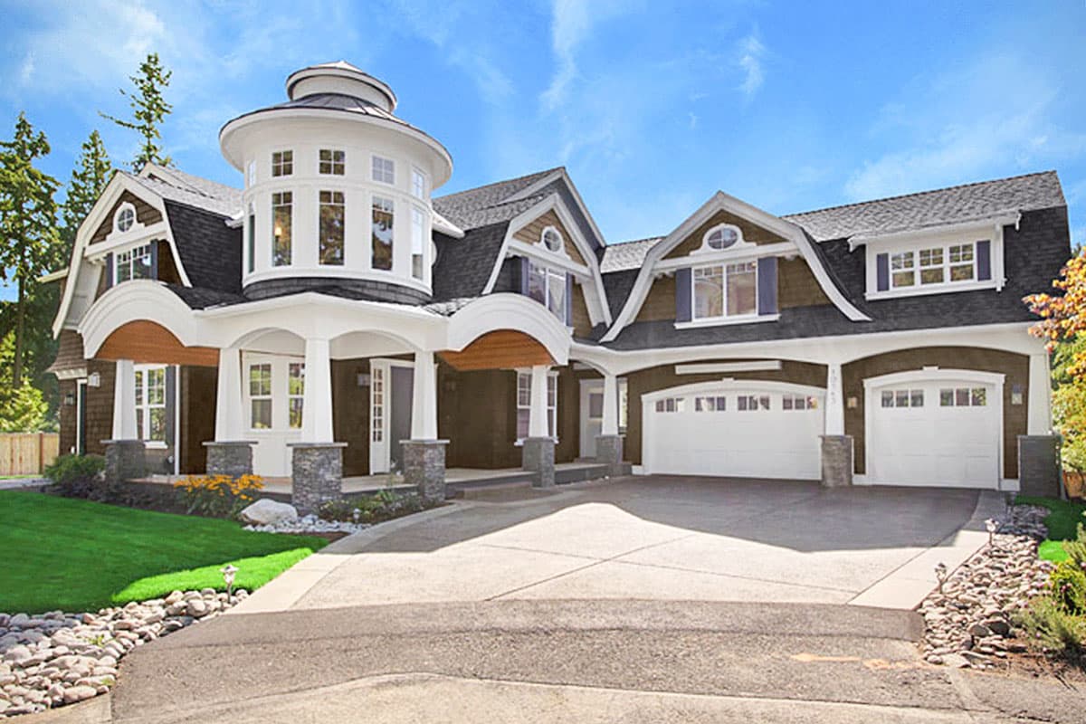 House plan exterior with Craftsman style, two stories, a turret, multiple gables, and a porte-cochere with arched detail.