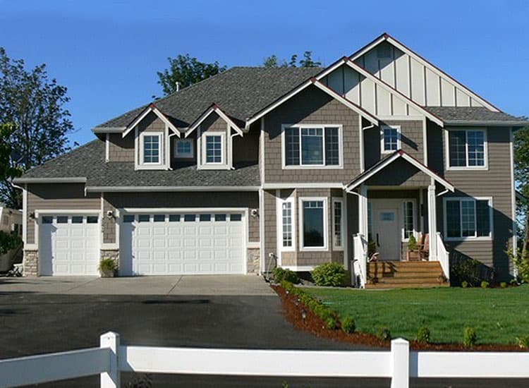 House plan exterior: Two-story home with a three-car garage, prominent gables, and a covered front porch.