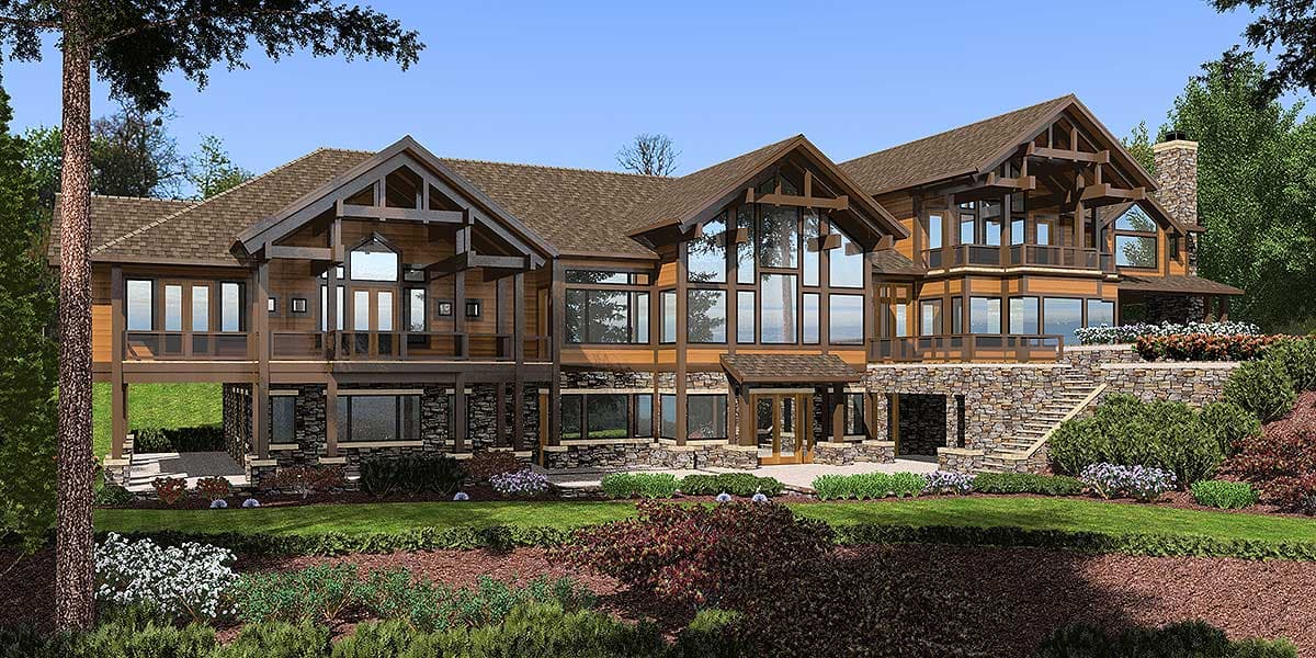 Log home exterior with stone foundation, multiple gables, and expansive glass windows.