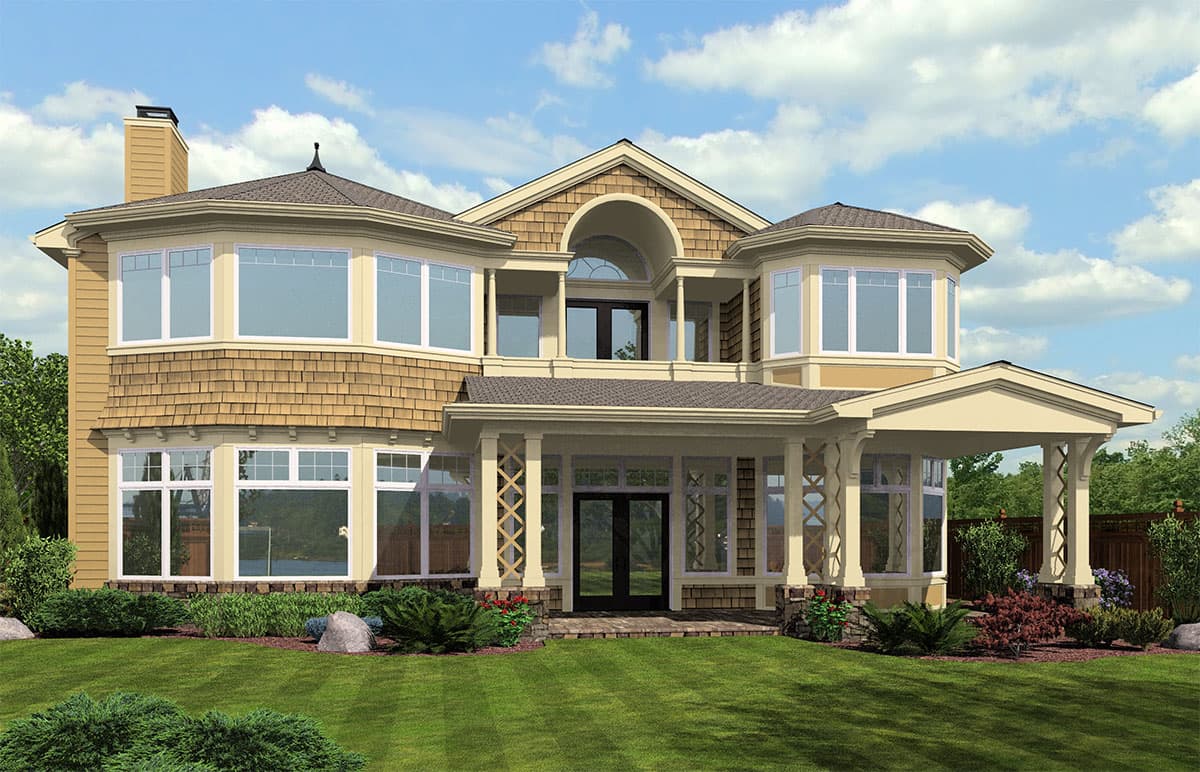 House plan exterior: Two-story home with multiple bay windows, shingle siding, covered front porch with decorative columns, and arched dormer.