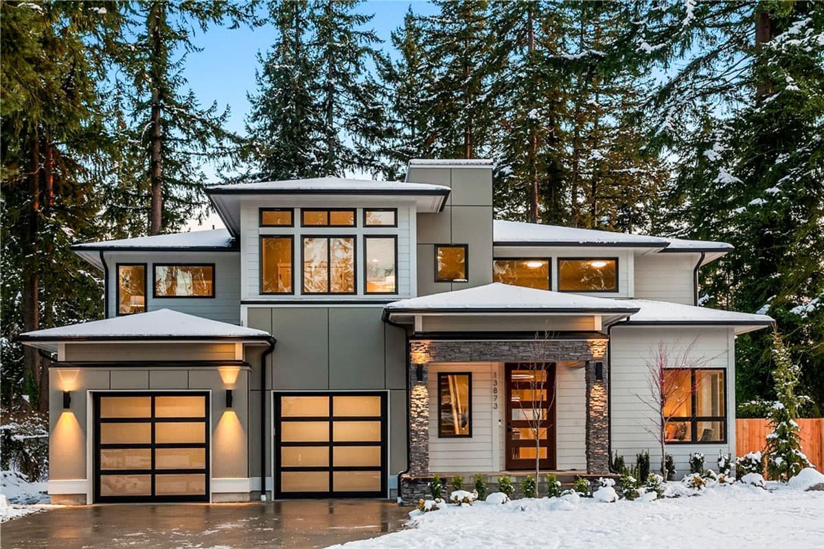 House plan exterior featuring a modern design, two stories, flat rooflines, and two garage bays with glass doors.