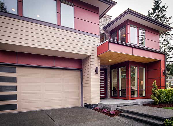 Modern house plan exterior with two stories, garage, cantilevered second story, and wood soffit detail.