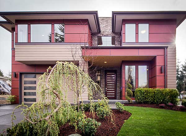 Modern two-story house plan exterior with horizontal siding, flat rooflines, glass garage door, and prominent entryway.