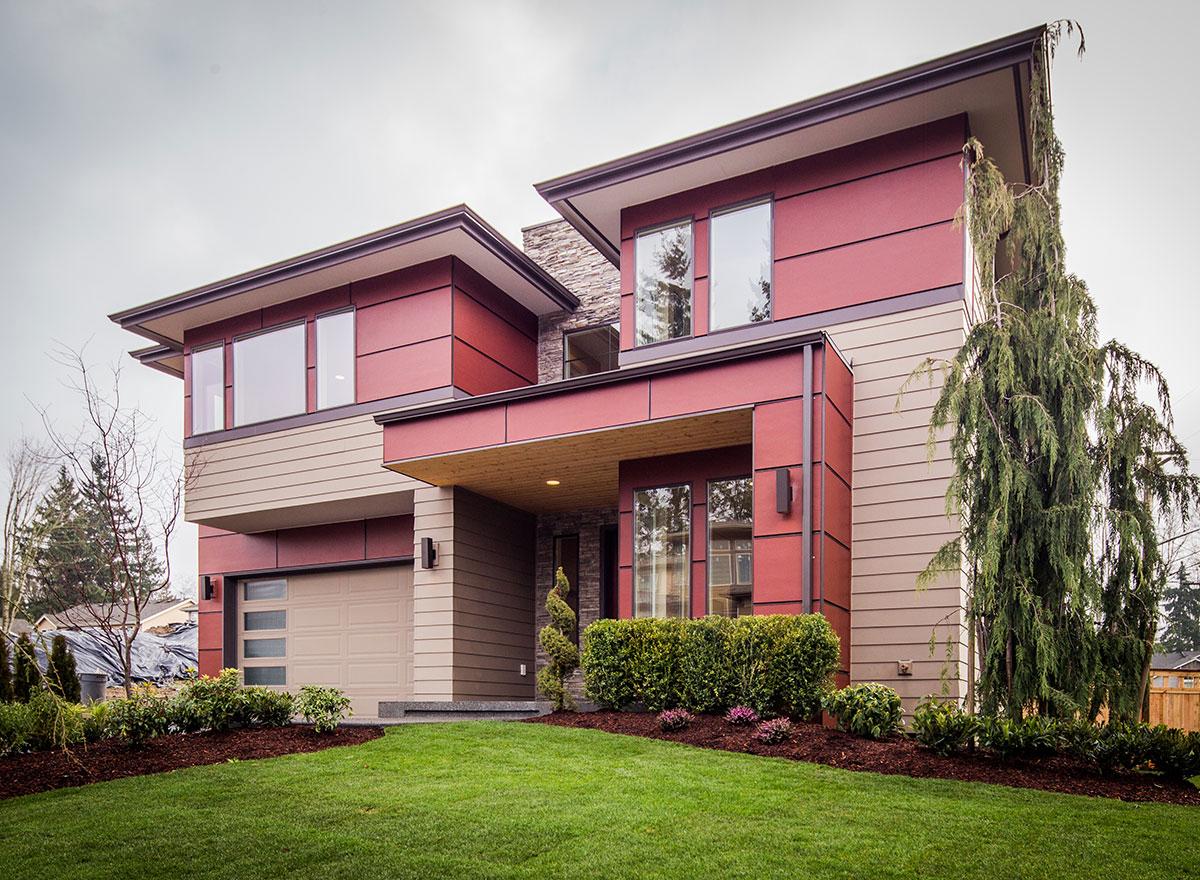 Modern house plan exterior with intersecting volumes, cantilevered rooflines, prominent stonework accent, and horizontal siding.