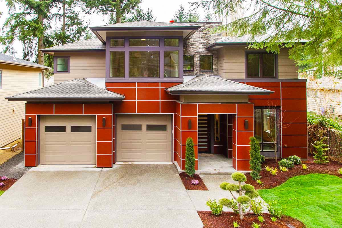 Modern two-story house plan exterior with a dual garage, intersecting rooflines, and prominent red paneling.