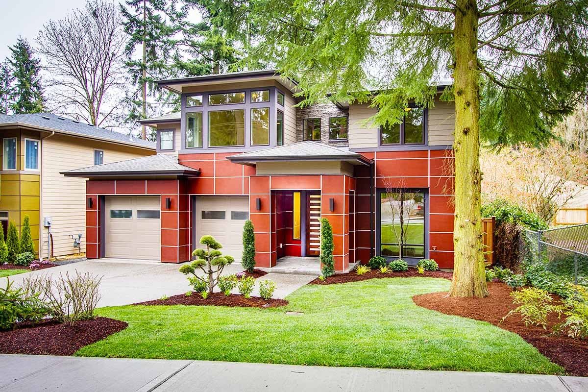 Modern two-story house plan exterior with red paneling, a flat roof, large windows, and a dual garage.