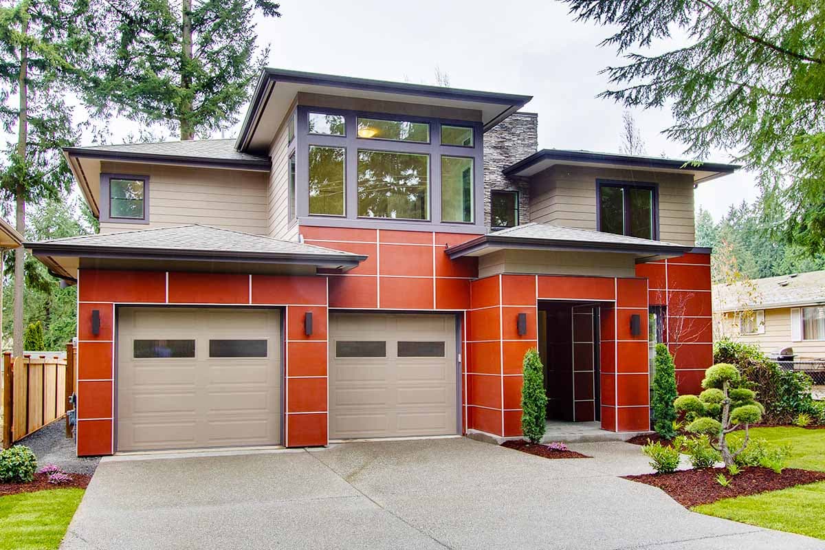 Modern house plan exterior featuring a stucco facade, multiple gables, large windows, and a triple-car garage.