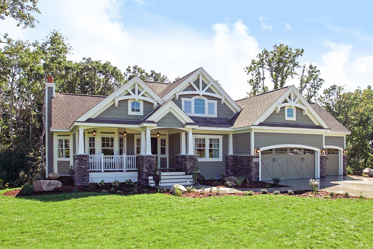 House plan exterior of a one-story home with a covered front porch, decorative gables, and a three-car garage.