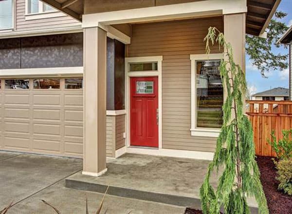 House plan exterior with tan siding, red front door with glass, large garage door, and covered porch.
