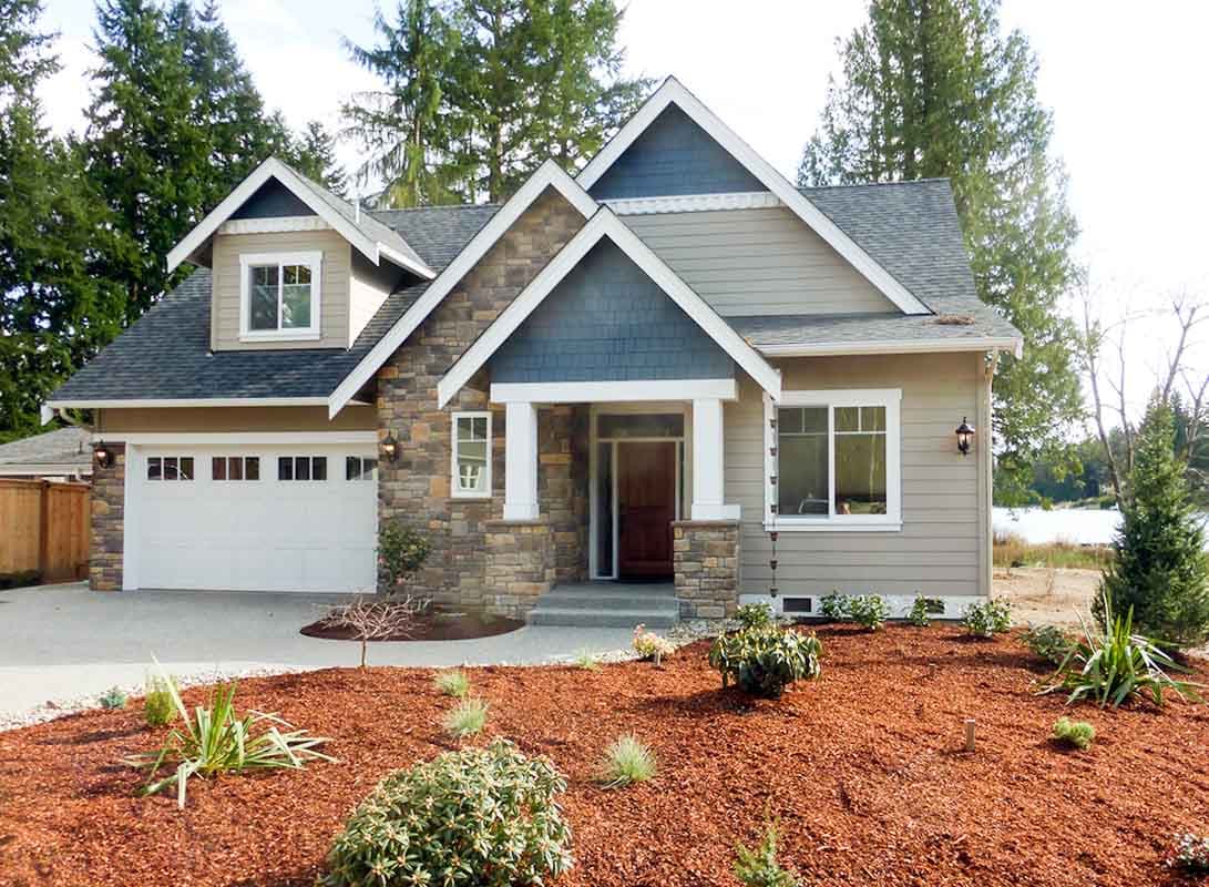 House plan exterior: Two-story Modern Farmhouse with stone accents, prominent gables, covered entry, and a two-car garage.