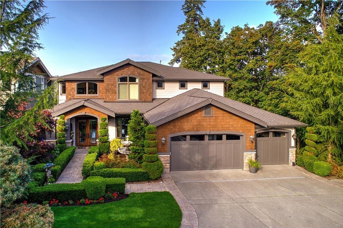House plan exterior with two stories, Craftsman style. Features include a covered entry, gabled roof, and attached two-car garage.