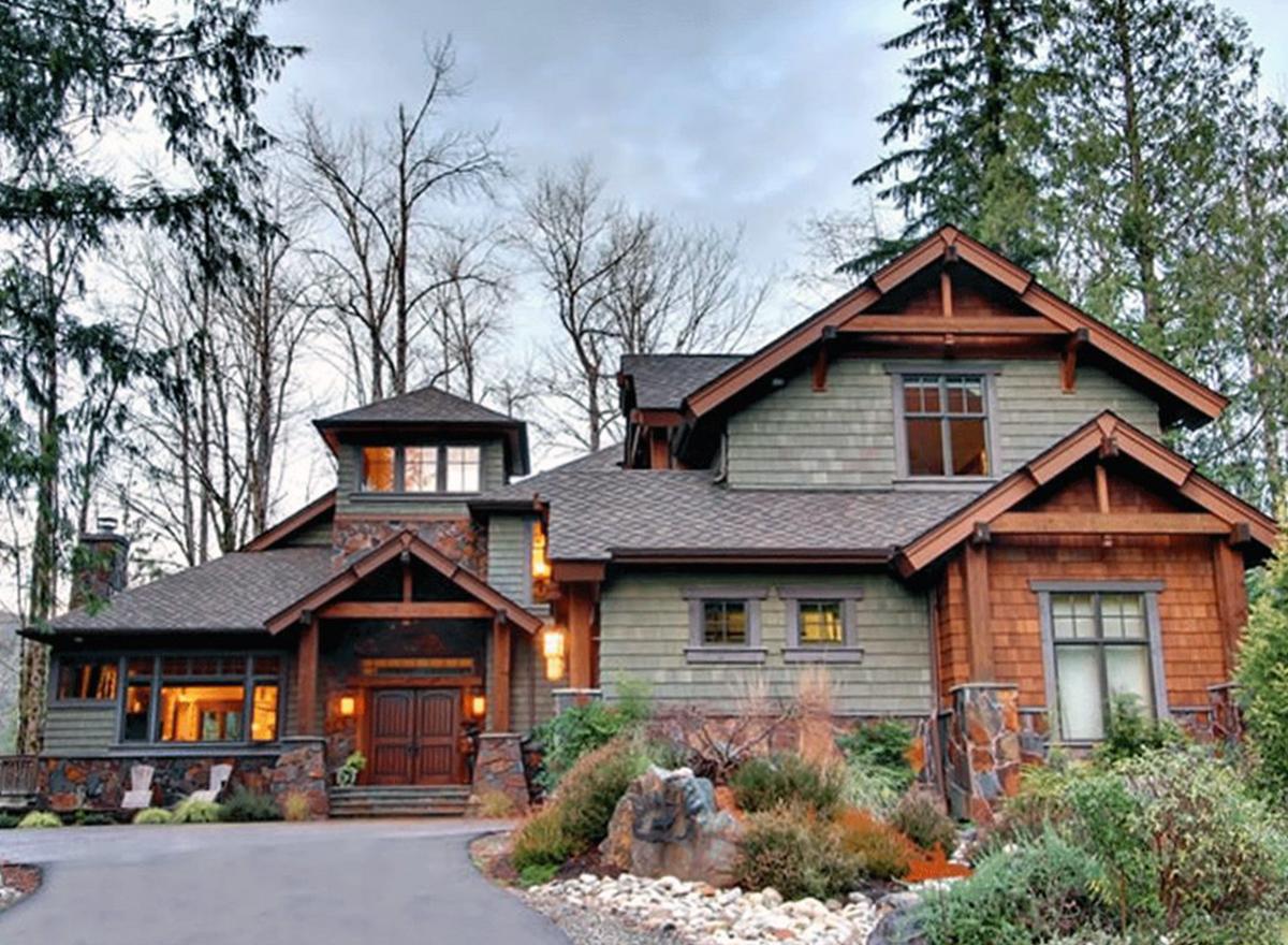 Craftsman style house plan exterior with stone base, wood accents, covered entry, dormers, and prominent gables.