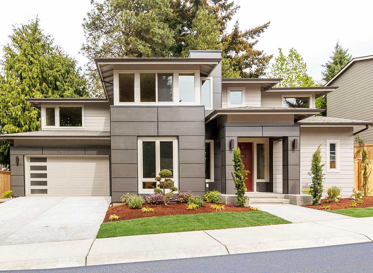 Modern house plan exterior with layered rooflines, horizontal siding, large windows, and a two-car garage.