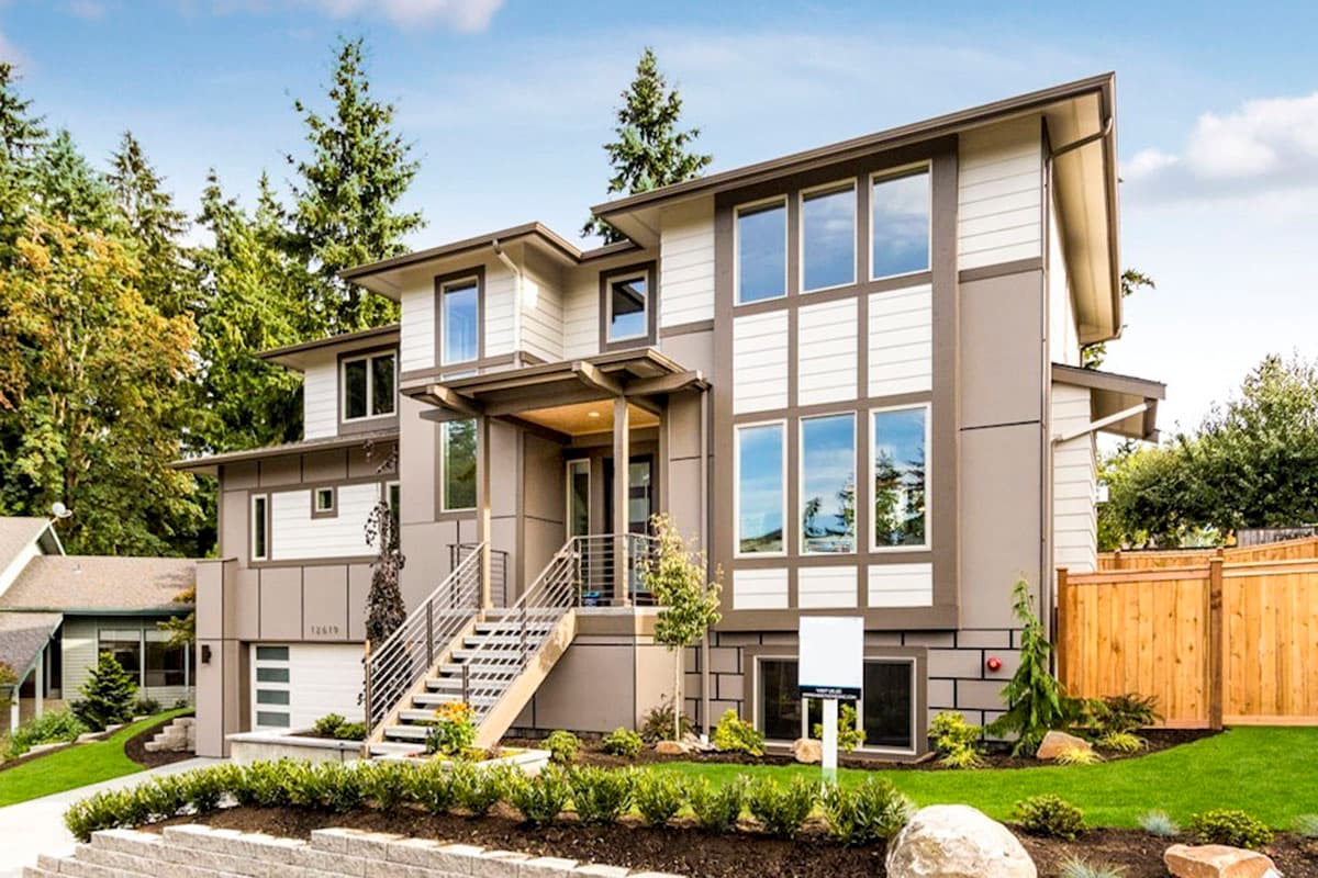 House plan exterior featuring a two-story modern home with a covered entry, multiple windows, and a combination of horizontal and vertical siding.