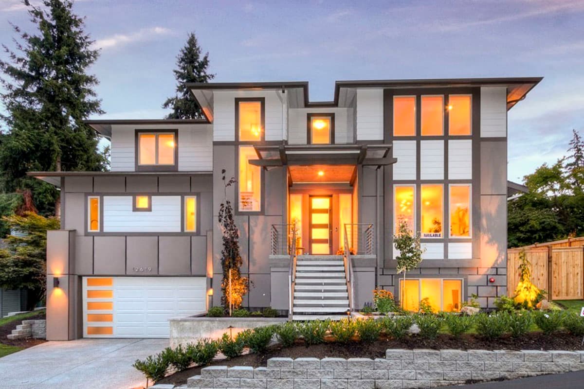 Modern two-story house plan exterior with multi-level rooflines, large windows, integrated garage, and prominent entryway.