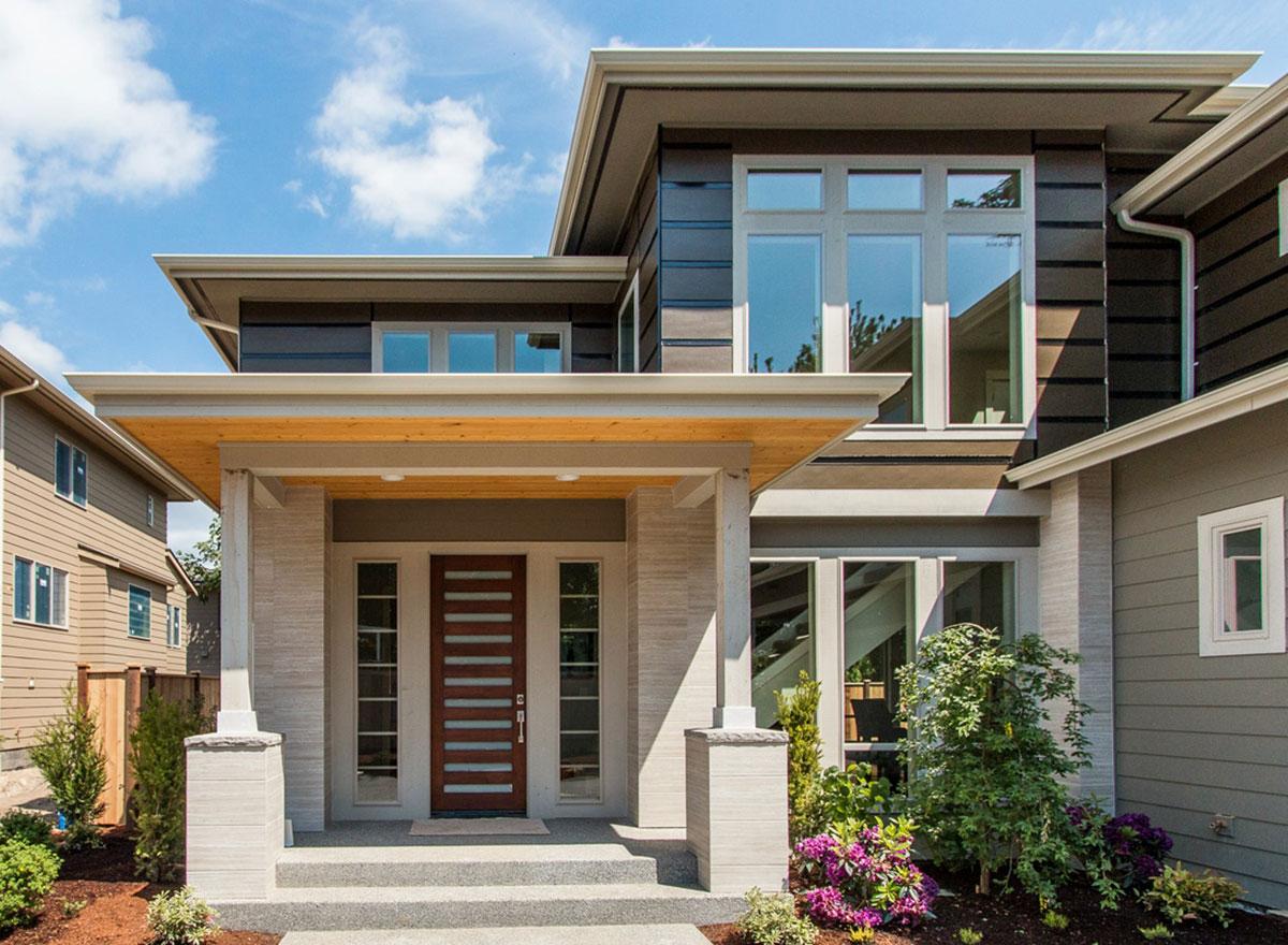 Modern house plan exterior with a covered entryway, horizontal siding, and a multi-pane window.