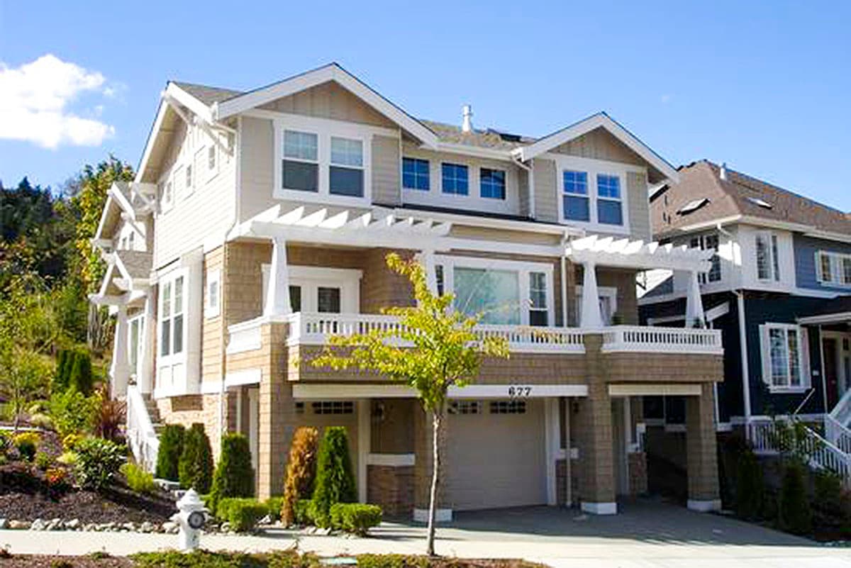 House plan exterior: Craftsman style, two stories, covered porch, dormers, and attached garage.