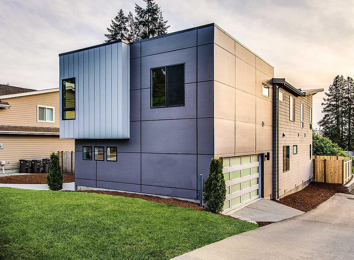 Modern house plan exterior, two stories, featuring geometric volumes, vertical metal siding, and a frosted glass garage door.
