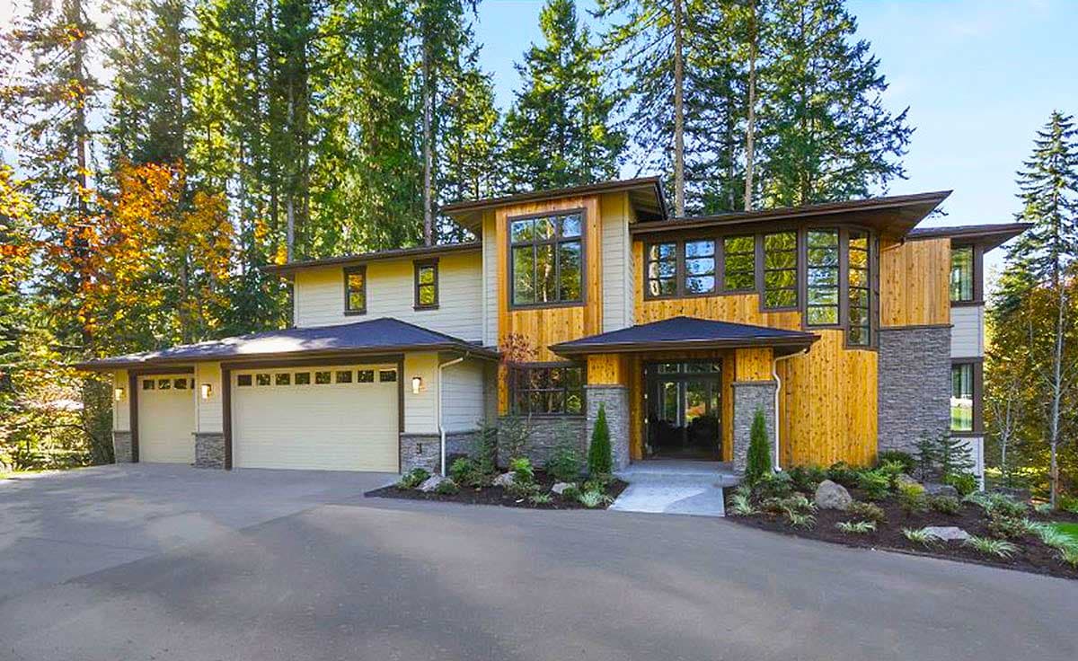 House plan exterior. Two-story home with a contemporary design. Features include a flat roof, wood siding, and a multi-car garage.