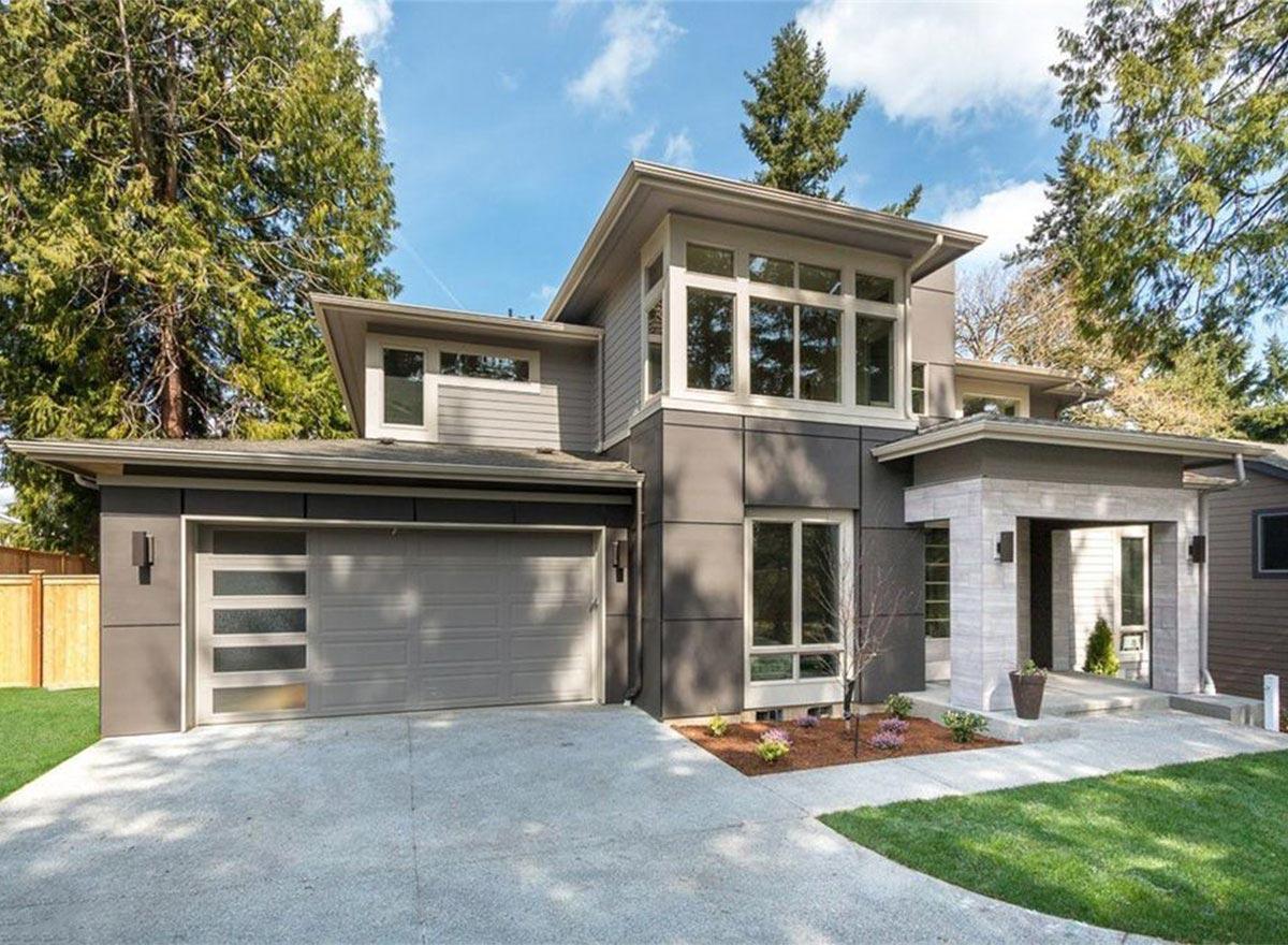 Modern house plan exterior with two stories, a two-car garage, a covered porch, and large window arrays.