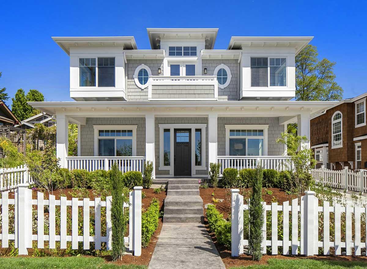 House plan exterior: Modern style two-story home with wrap-around porch, layered gables, and prominent rooflines.