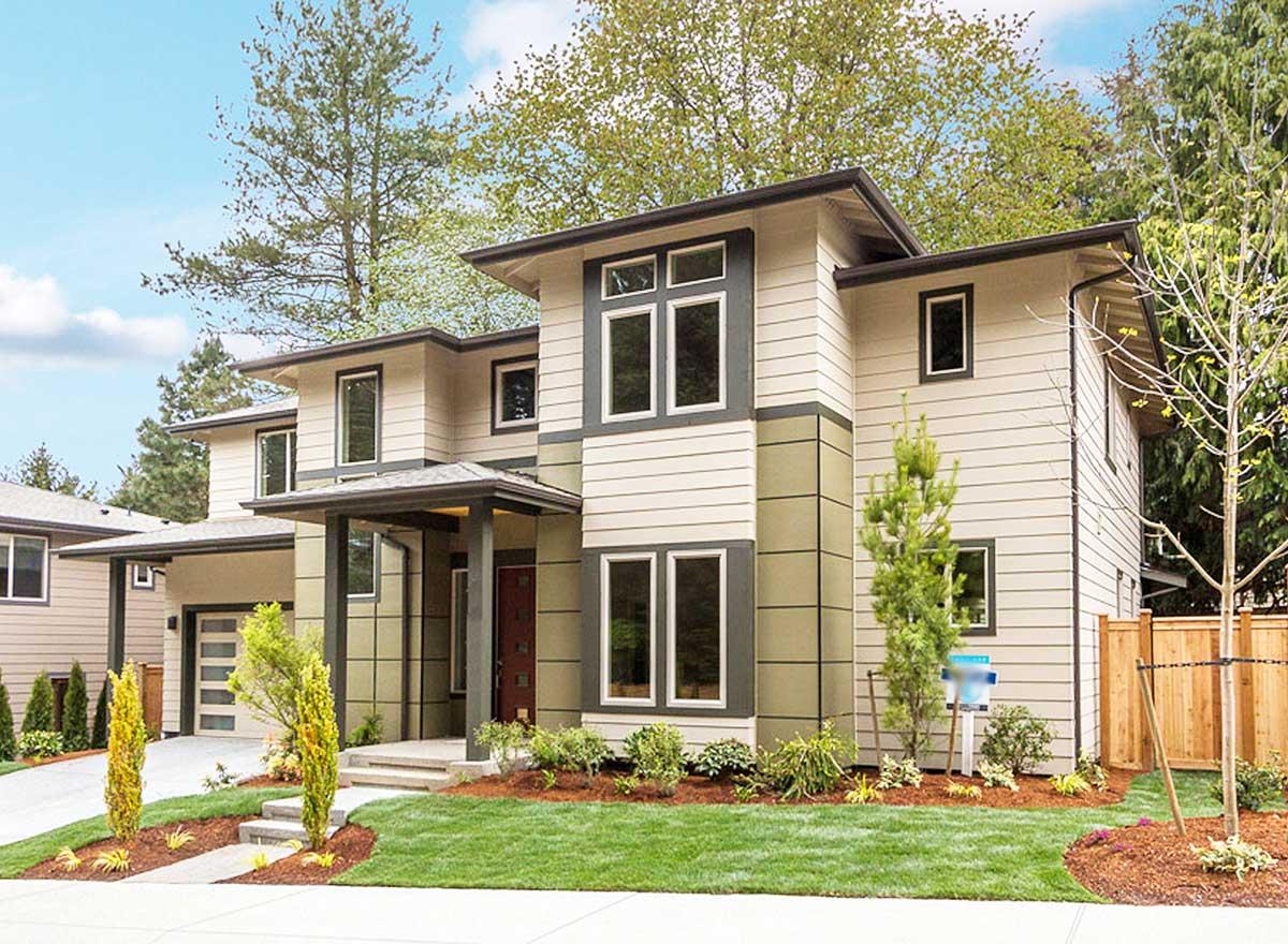Modern two-story house plan exterior with a covered entry, multi-pane windows, and an attached garage.