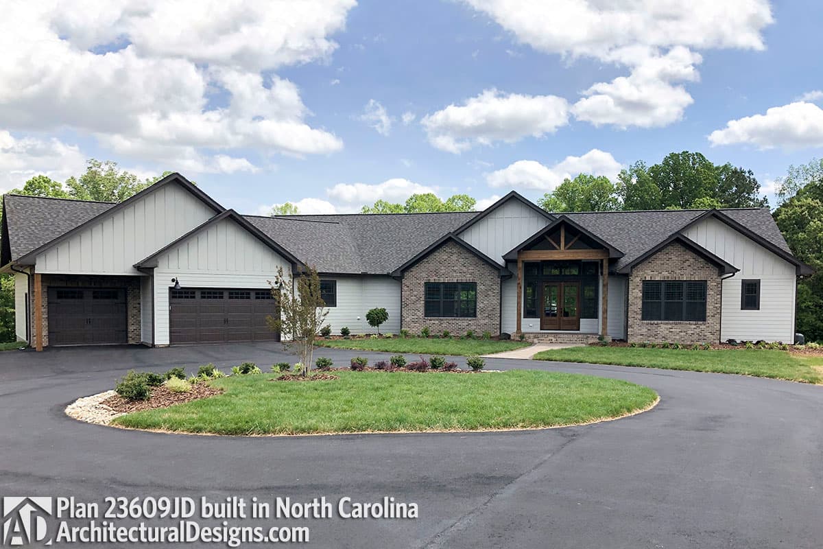 House plan exterior: Modern Ranch with three-car garage, gabled rooflines, brick and board-and-batten siding, and covered entry.