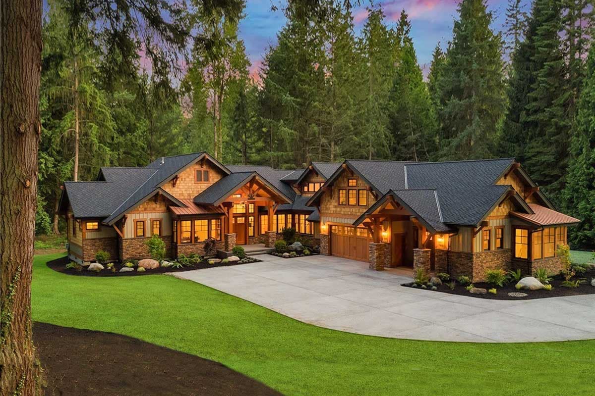 Craftsman style house plan exterior with stacked stone accents, wood shake siding, multiple gables, and a triple garage.