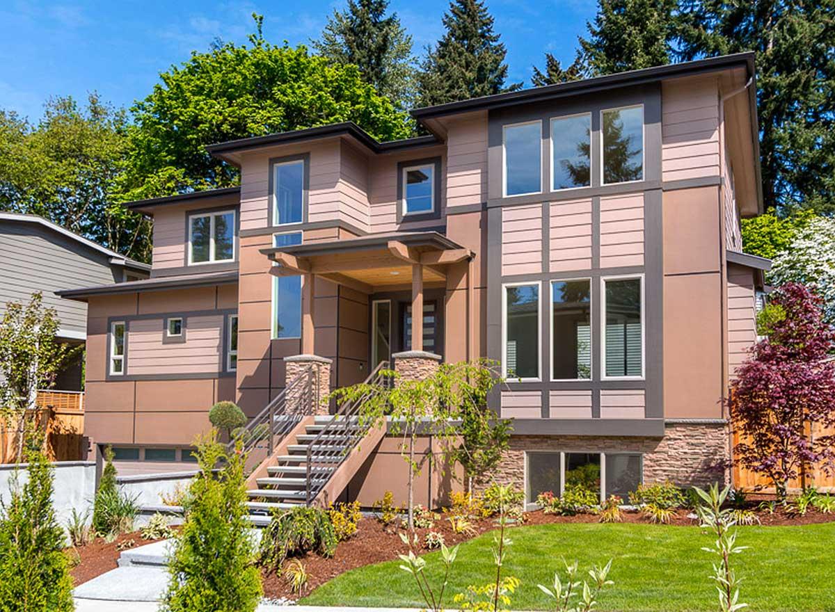 House plan exterior. Two-story Modern house with a covered porch, stone accents, and multiple large windows. Features include a side-entry garage.