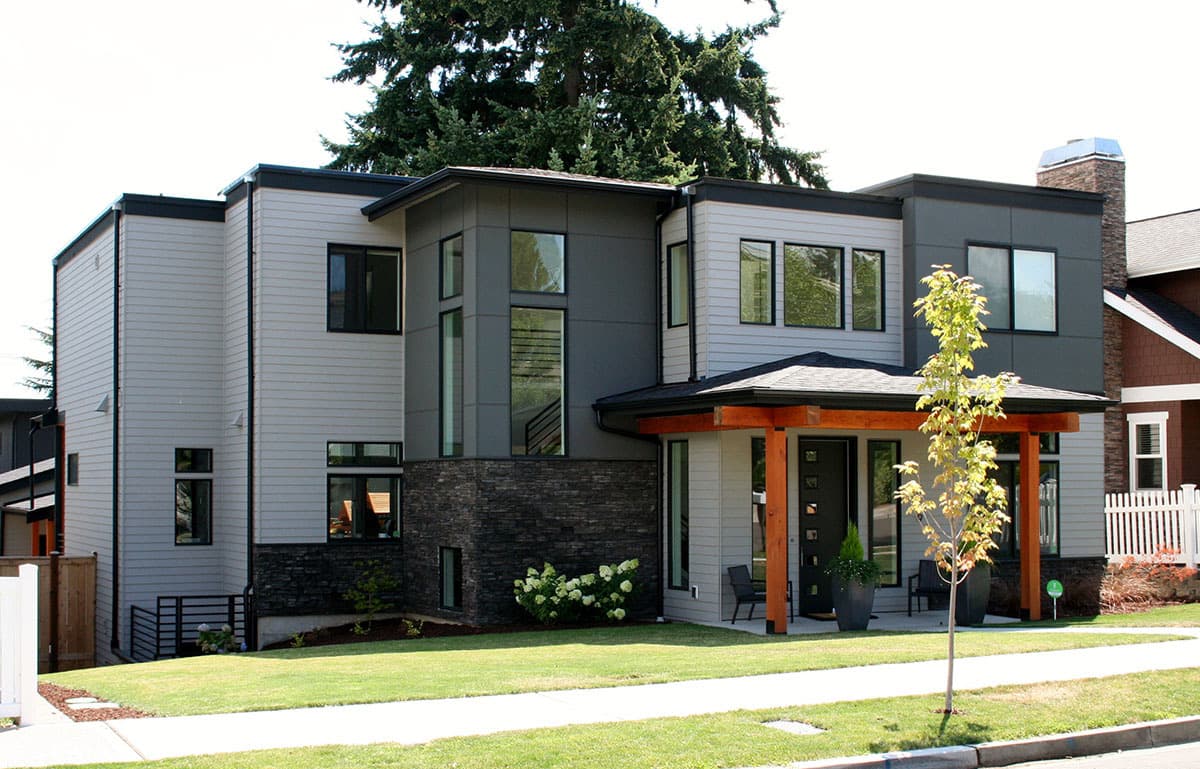 Modern two-story house plan exterior with horizontal siding, stacked stone accents, flat rooflines, and a covered entry with wood posts.