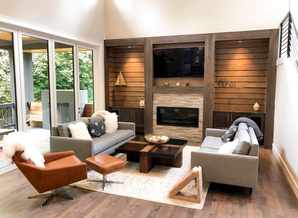 Living room with fireplace, built-in shelving, large sliding glass doors, and contemporary furniture.