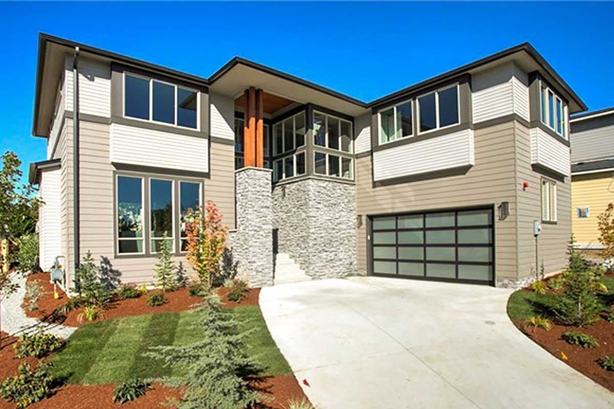 Modern house plan exterior featuring two stories, stone facade, wood columns, and a glass garage door.