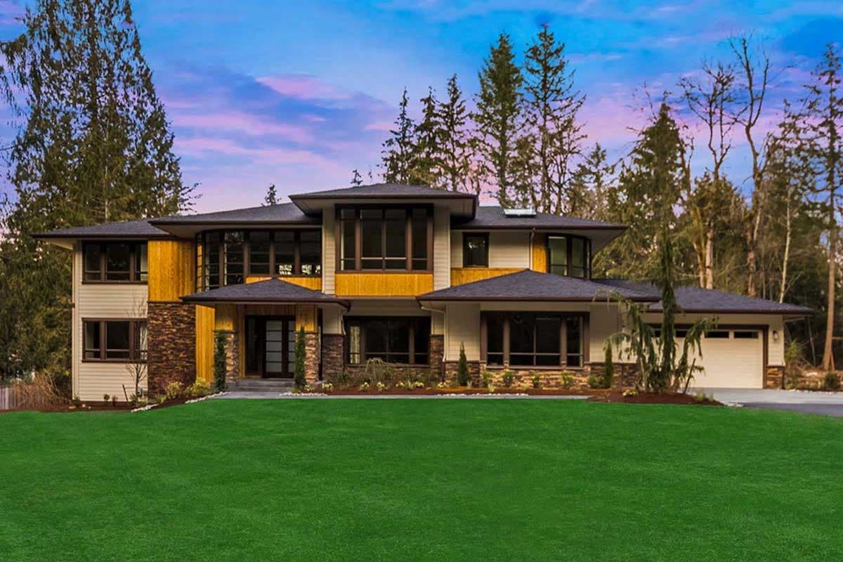 Modern style two-story house plan exterior with a prominent entry, stone and wood accents, and a two-car garage.