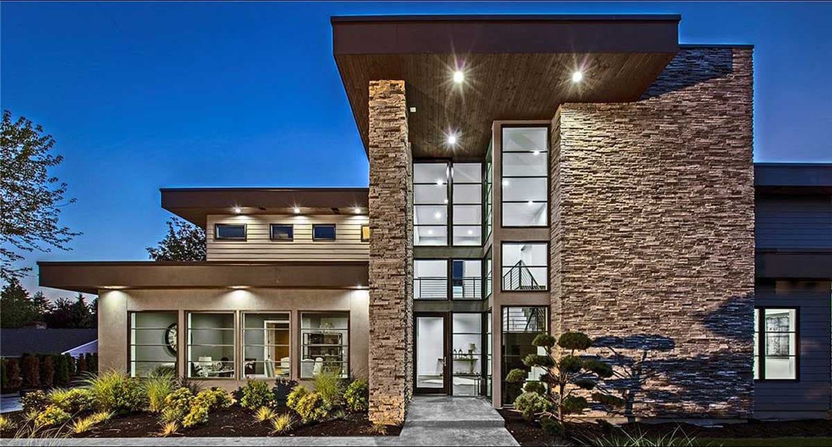 House plan exterior with modern design. Two-story structure featuring a stacked stone facade, flat rooflines, and large windows. Recessed entry door.