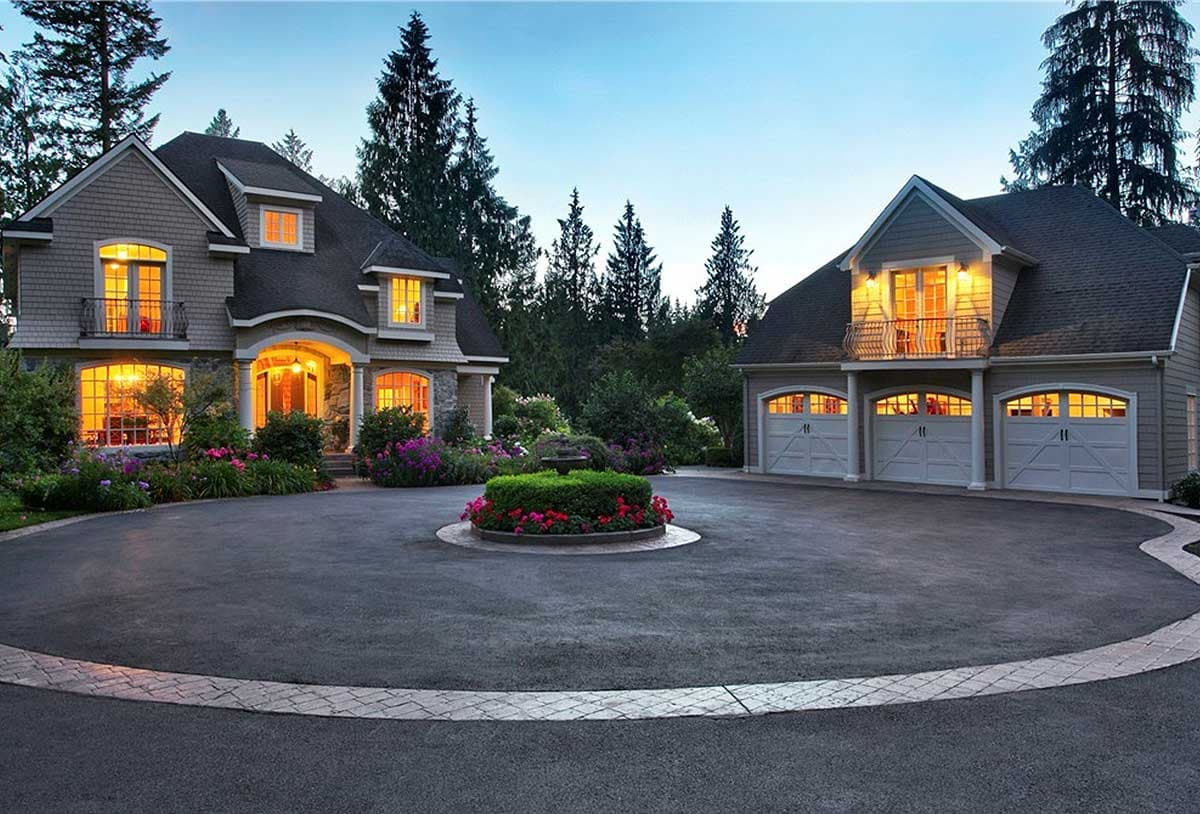 House plan exterior: Two-story home with arched entry, dormers, and three-car garage. "