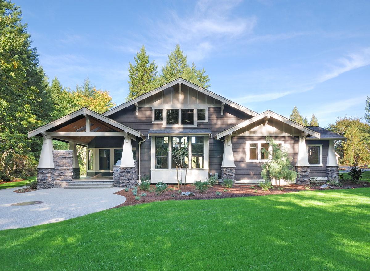 Craftsman style house plan exterior with a covered entry porch, stone accents, gables, and multiple windows.