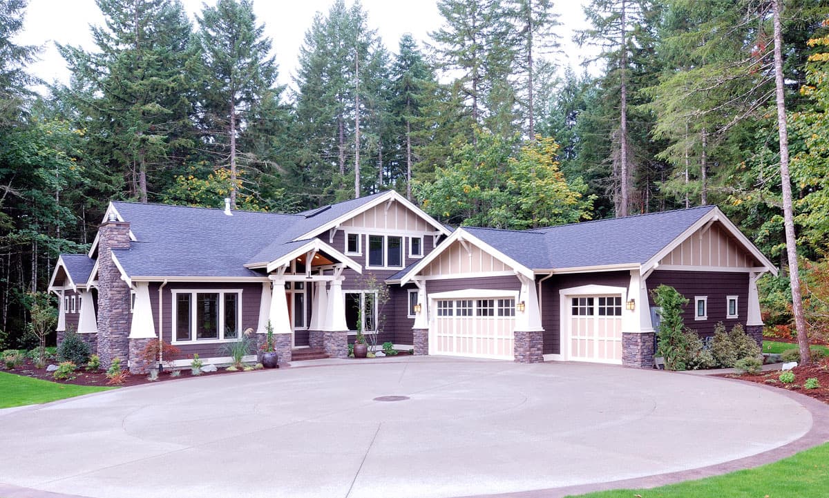 Craftsman style house plan exterior with stone accents, a covered entry, gabled dormers, and a triple garage.
