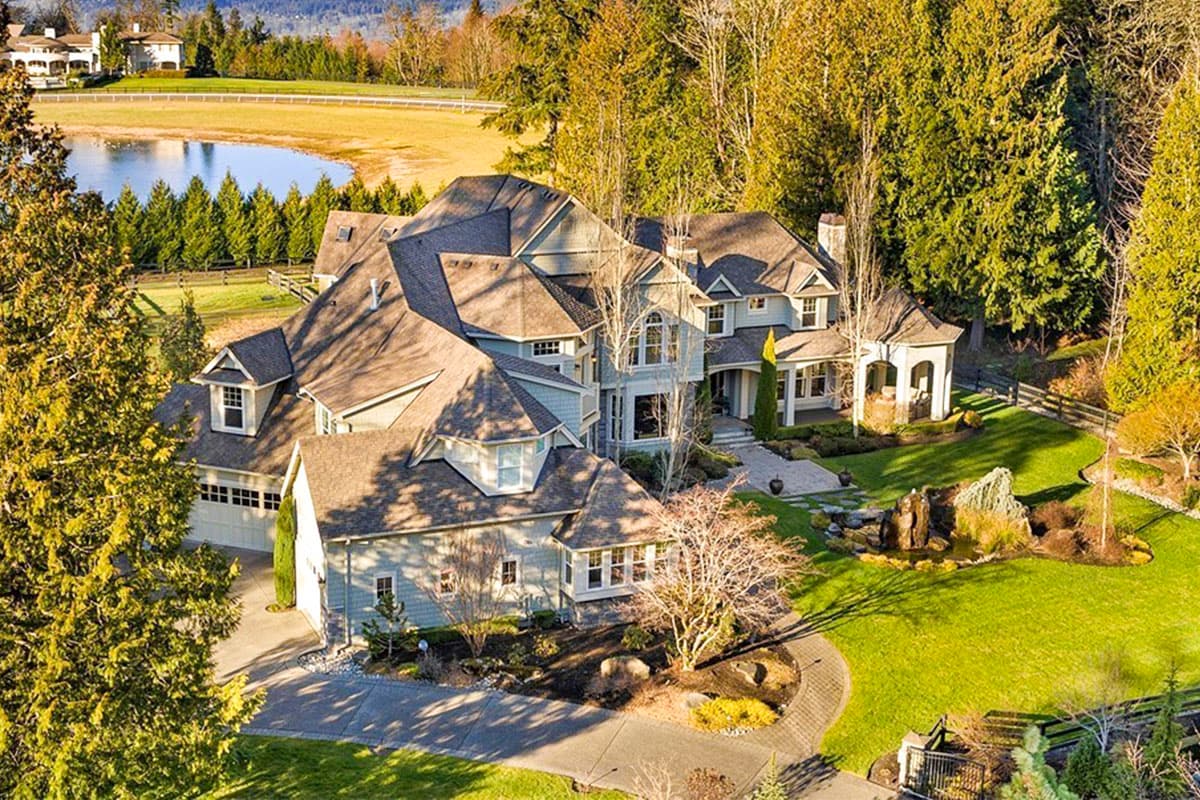 House plan exterior of a large, multi-story home with a complex roofline, dormers, and a detached garage.