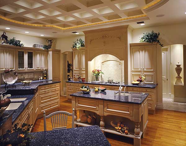 Kitchen with coffered ceiling, granite countertops, central island, and detailed cabinetry.