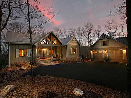 House plan exterior: Modern Farmhouse style, one story with metal roof, prominent gables, stone accents, and attached two-car garage.