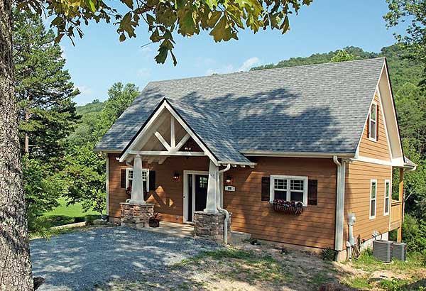 Craftsman style house plan exterior with a prominent gabled entryway supported by stone and white columns.