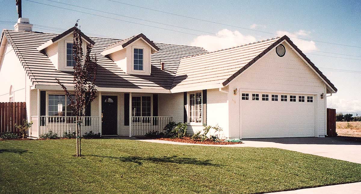House plan exterior: Two-story Modern Farmhouse with a front-facing gabled garage, dormer windows, and a covered porch.