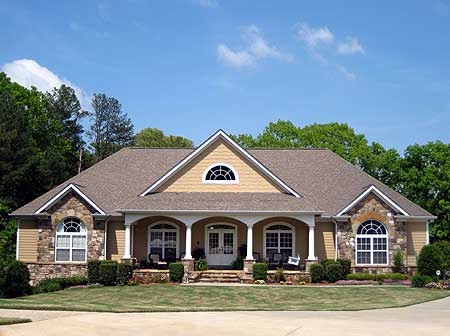 House plan exterior: one-story, stone accents, arched windows, covered front porch with columns, and central gable with arched window.