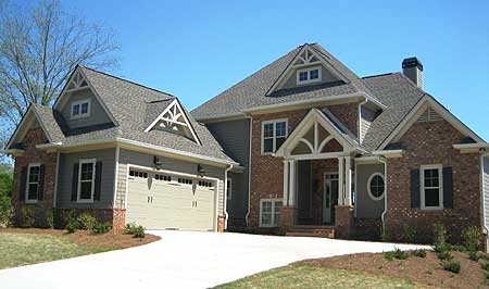 House plan exterior with two-car garage, brick and siding, gabled dormers, arched entry, and roof gables.