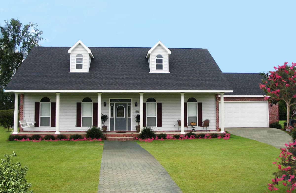 House plan exterior of a one-story home with a central covered porch, dormers, and an attached two-car garage.