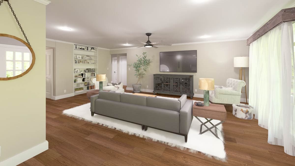 Living room with grey sofa, built-in shelving, media console, and large window with sheer curtains.