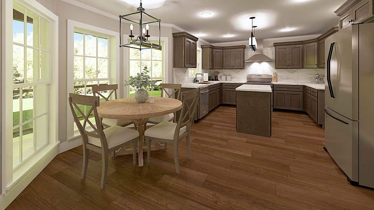 Kitchen with dark wood cabinetry, island, stainless steel appliances, and adjacent dining area with round table and chairs.