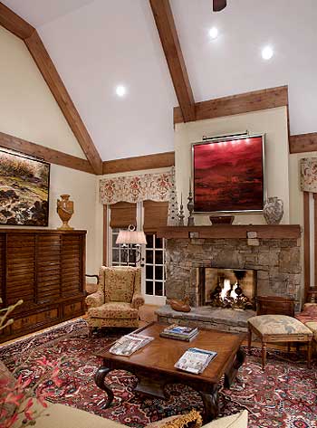 Living room with vaulted beamed ceiling, stone fireplace, and large cabinet.