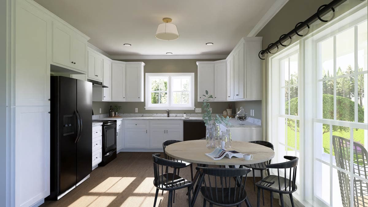 Bright, modern kitchen with white cabinets, a black refrigerator, and a round wooden table surrounded by black chairs. Large windows offer a view.