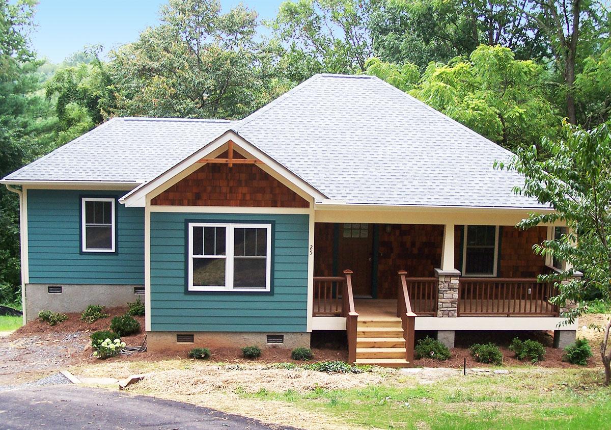 Ranch style house plan exterior with a covered front porch, stone column accents, and cedar shake gable detail.